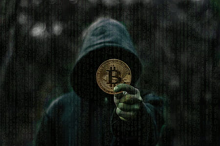 person showing round gold-colored Bitcoin coin thumbnail