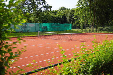 tennis court surrounded with trees thumbnail