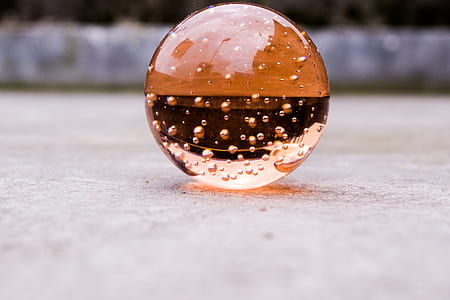 selective focus photography of amber glass ball thumbnail