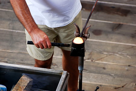 man wearing white shirt and holding tools standing on the ground thumbnail