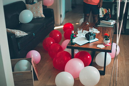 red and white balloon under the brown wooden table thumbnail