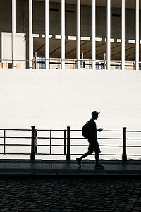 silhouette of walking man along sidewalk thumbnail