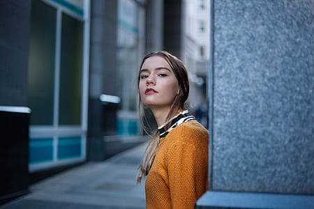 woman learning against concrete wall during daytime thumbnail