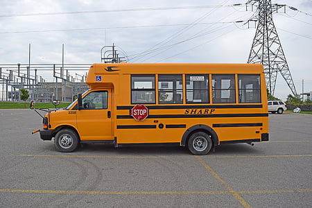 school bus beside transmission tower thumbnail