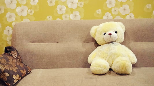 white bear plush toy on brown fabric sofa thumbnail