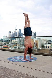 Man Wearing Black Shorts Doing Hand Stand thumbnail