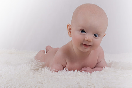 naked baby on top of white textile thumbnail