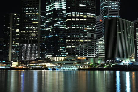 buildings near body of water at night thumbnail
