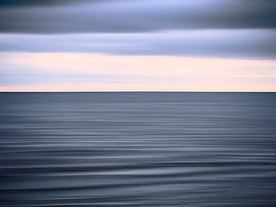horizon of body of water and clouds thumbnail