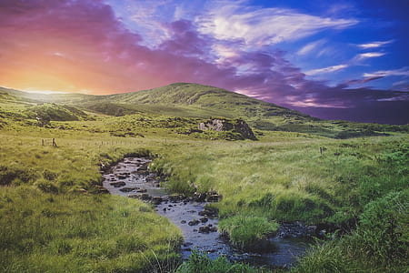 water stream near mountain at daytime thumbnail