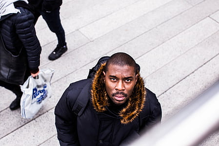man in black fur jacket during daytime thumbnail