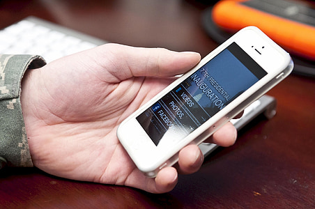 person holding turned-on white iPhone 5 thumbnail