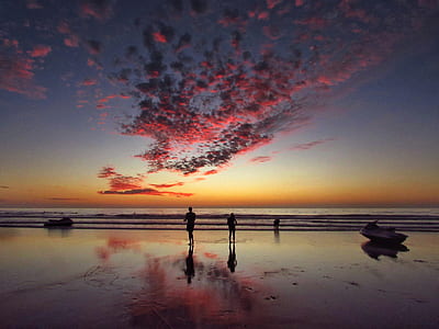 reflection photography of people at beach during golden hour thumbnail