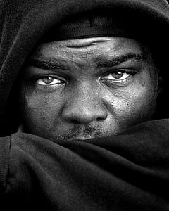 grayscale photo of man's face wearing hooded jacket thumbnail