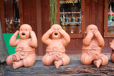 three wise baby statue on brown wooden plank thumbnail