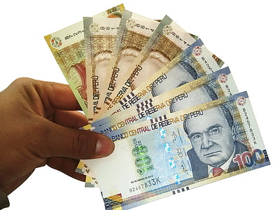 person holding assorted-denominations Peru banknotes thumbnail