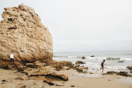 boy running on seashore under clear sky thumbnail
