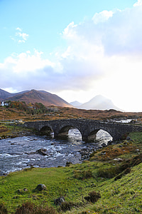 photo of gray bridge far away from mountain thumbnail