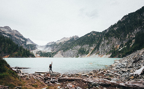 man standing near water body during daytime thumbnail