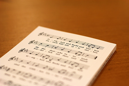 selective focus photography of music notebook thumbnail