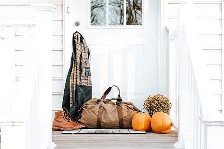 brown duffel bag outside door thumbnail