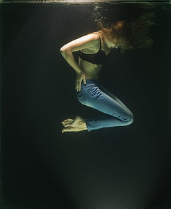 underwater photography of woman wearing black bra and blue denim jeans thumbnail