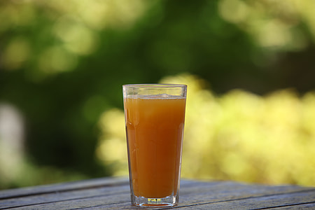 clear drinking glass filled with orange liquid thumbnail
