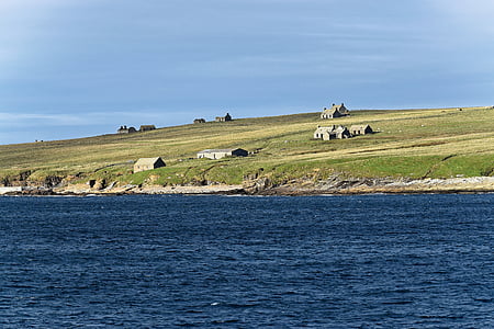 brown house near sea at daytime thumbnail