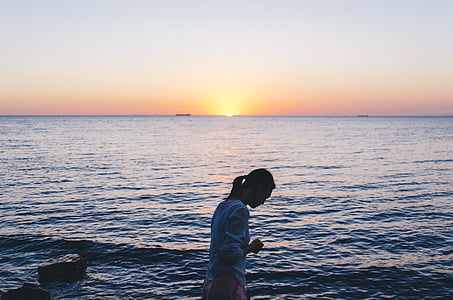 woman on sea during sunset thumbnail