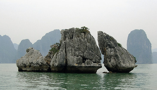 gray rock formation in the midst of sea thumbnail