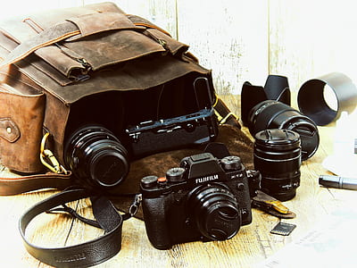 black Fujifilm camera with lenses beside brown bag thumbnail