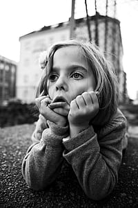 grayscale photography of girl leaning on concrete surface during daytime thumbnail