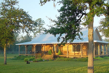 brown and white house on grass field thumbnail