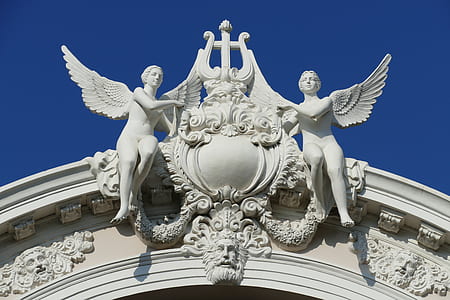 low angle photography of white angel statues thumbnail