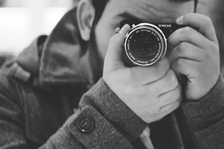 Man Taking Photo Using Black Dslr Camera thumbnail