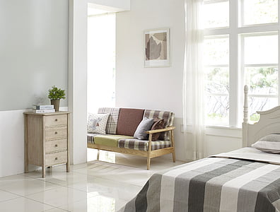 white wooden bed and gray and white striped bed linen thumbnail