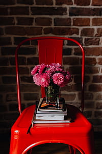 Industrial metal chair with a bouquet of pink flowers and books on it thumbnail