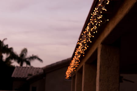 lighted string lights hanged on house thumbnail