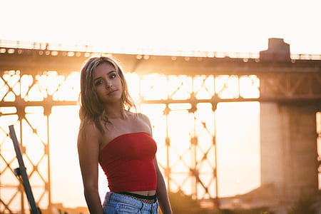 woman posing in front of bridge during sunset thumbnail