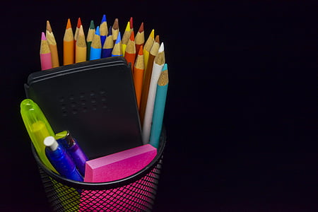 assorted-color color pencil and pen on black metal rack thumbnail