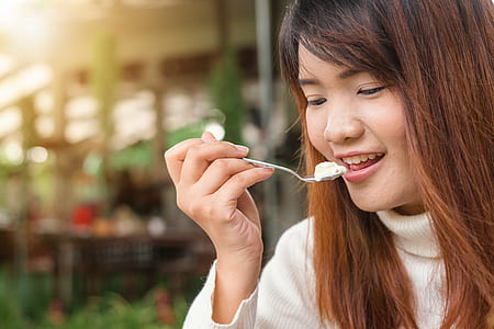 Woman Holding Spoon Trying to Eat White Food thumbnail