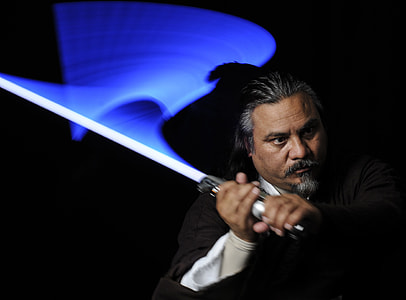 man wearing black top holding sword thumbnail
