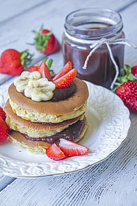 pancake with strawberries and jam on plate thumbnail
