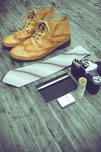 pair of brown leather shoes, necktie, MILC, pen, and money on parquet floor thumbnail