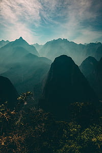 aerial photography of mountain under white sky at daytime thumbnail
