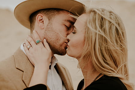 close-up photography of man and woman kissing thumbnail