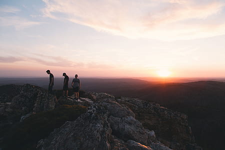 three persons hiking on gray mountain thumbnail