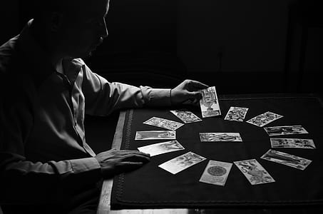person in dress shirt in front of table with cards thumbnail
