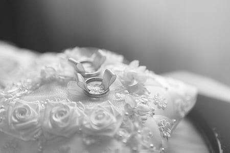 selective focus photo of silver-colored bridal ring on white lace pillow thumbnail