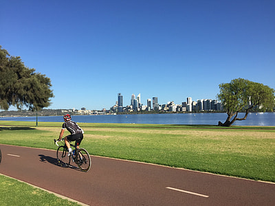 man riding road bike on grey pavement during daytime thumbnail